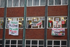 banners showing from the window of the occupied space in manchester uni